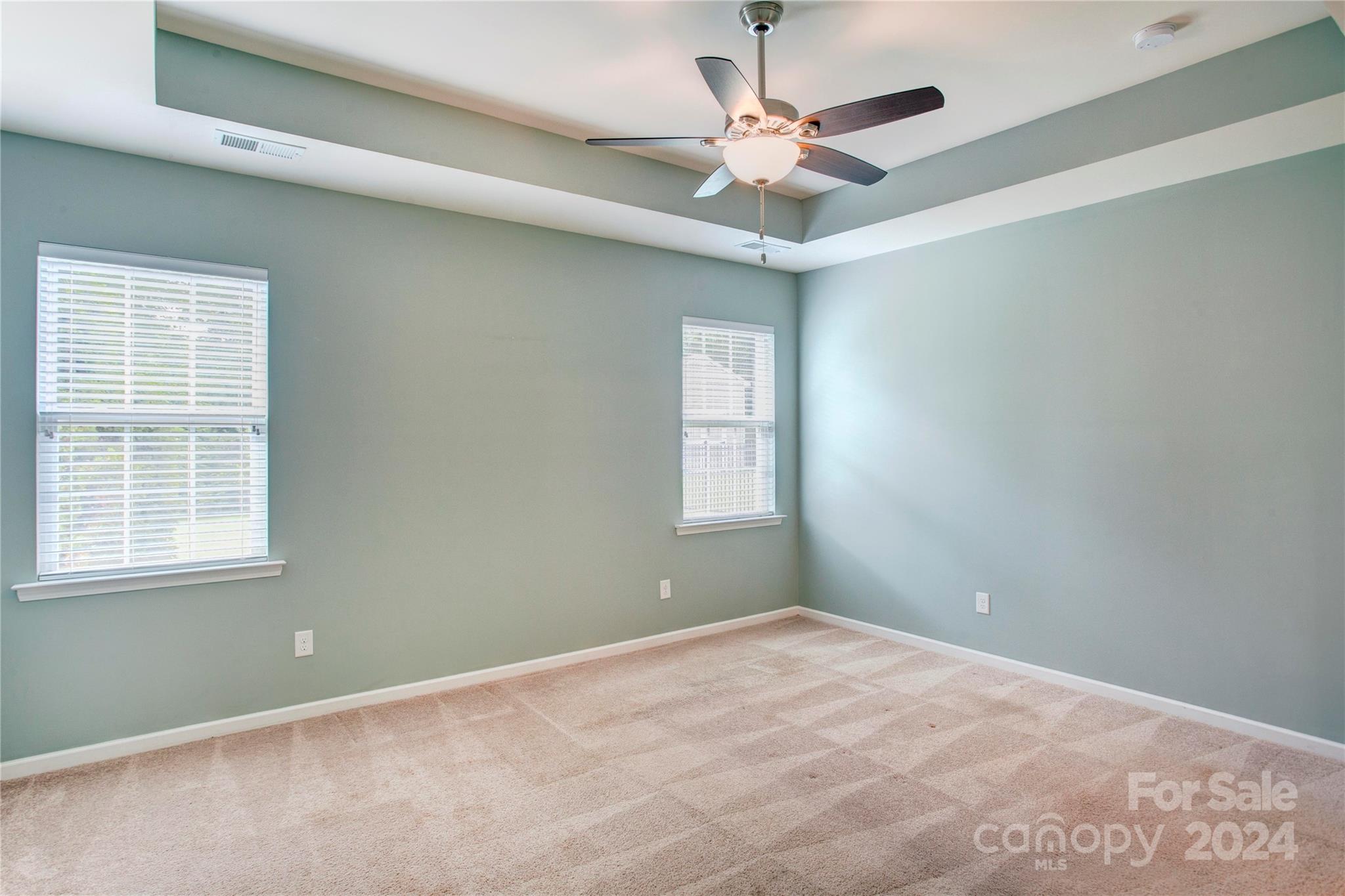 8899 Happiness Road Harrisburg, NC 28075 - Photo 13 of 30 an empty room with a window and a fan