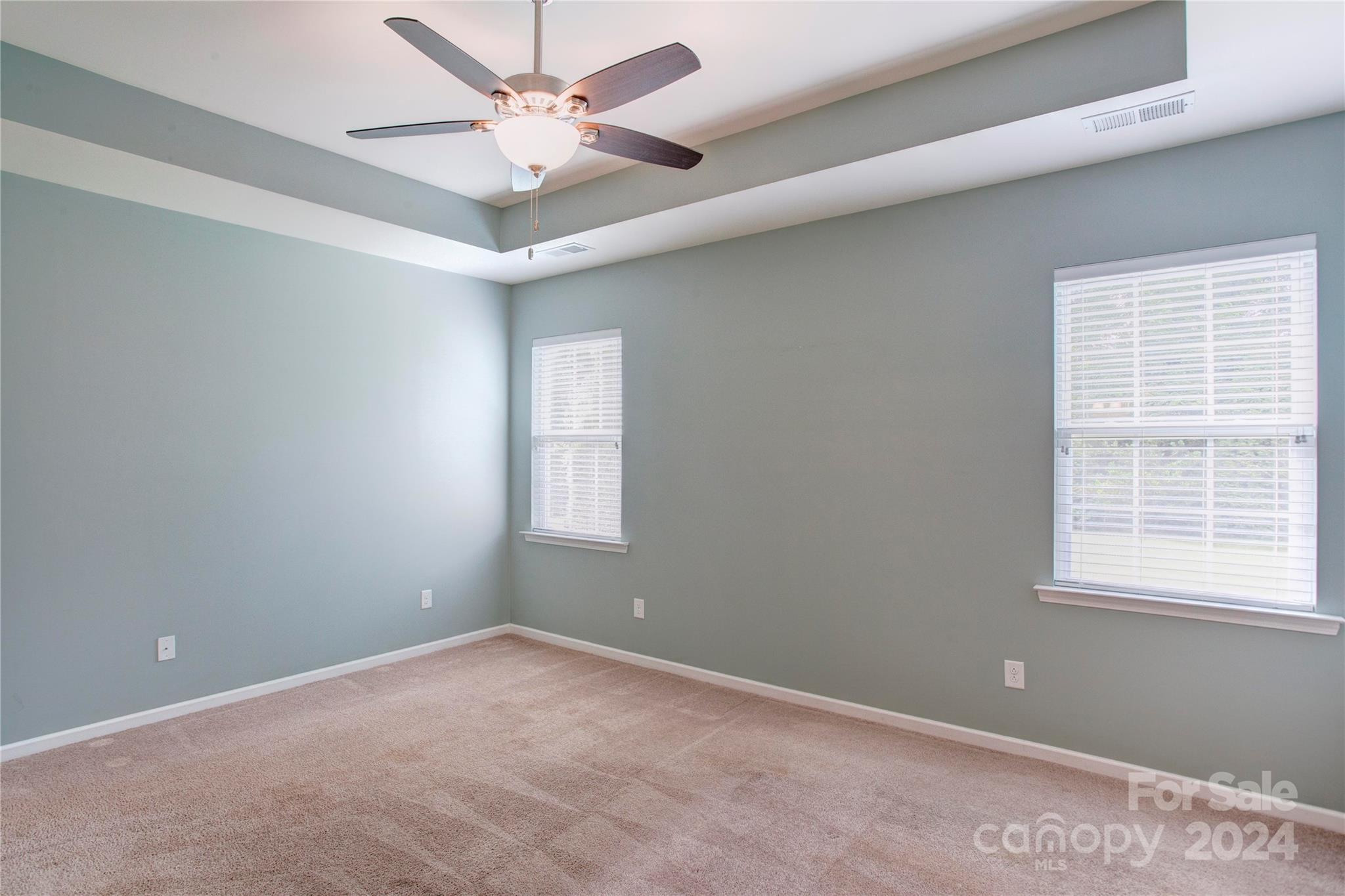 8899 Happiness Road Harrisburg, NC 28075 - Photo 14 of 30 an empty room with a window and a fan