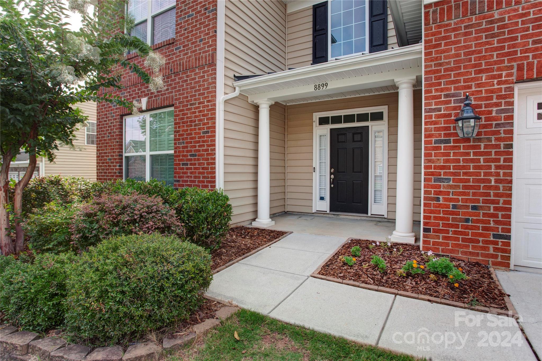 8899 Happiness Road Harrisburg, NC 28075 - Photo 2 of 30 a front view of a house with garden
