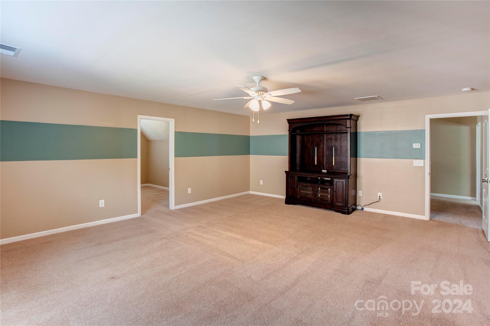 8899 Happiness Road Harrisburg, NC 28075 - Photo 24 of 30 a view of an empty room with a ceiling fan