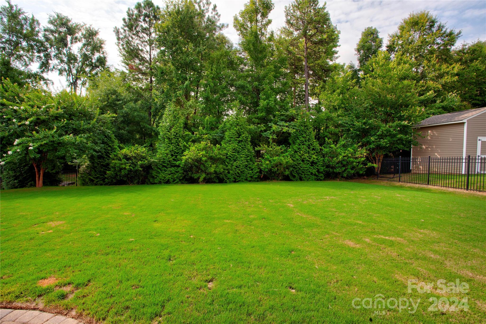 8899 Happiness Road Harrisburg, NC 28075 - Photo 28 of 30 a view of a backyard with a garden
