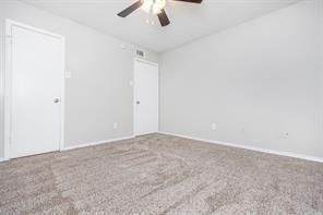 1826 Esters Road, Unit 3024 Irving, TX 75061 - Photo 25 of 30 an empty room with a ceiling fan and carpet
