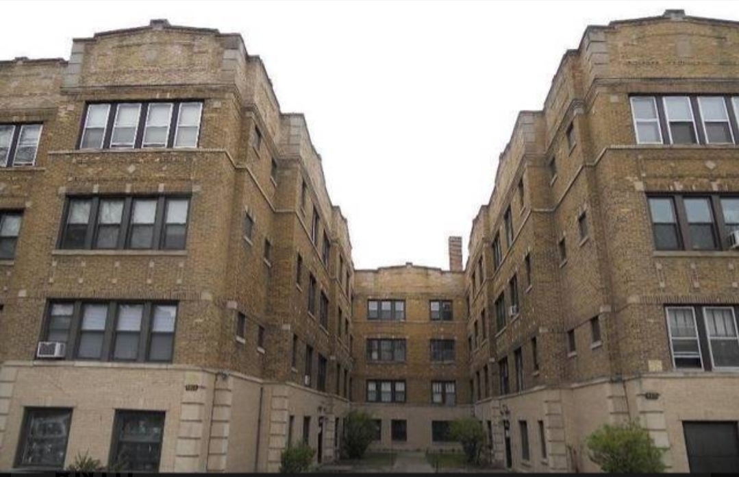 4817 North Springfield Avenue, Unit 1E Chicago, IL 60625 - Photo 1 of 6 a tall building sitting next to a tall building
