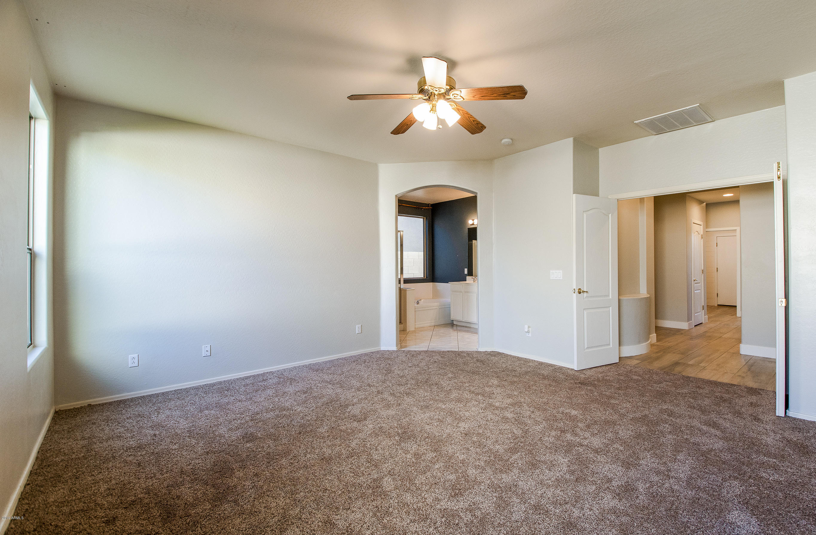 3236 East Phelps Street Gilbert, AZ 85295 - Photo 13 of 29 a view of a livingroom with a chandelier fan and a bathroom