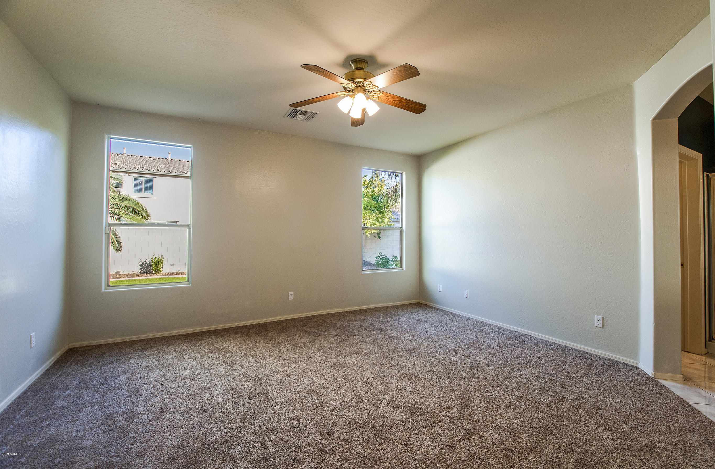 3236 East Phelps Street Gilbert, AZ 85295 - Photo 14 of 29 an empty room with windows and fan