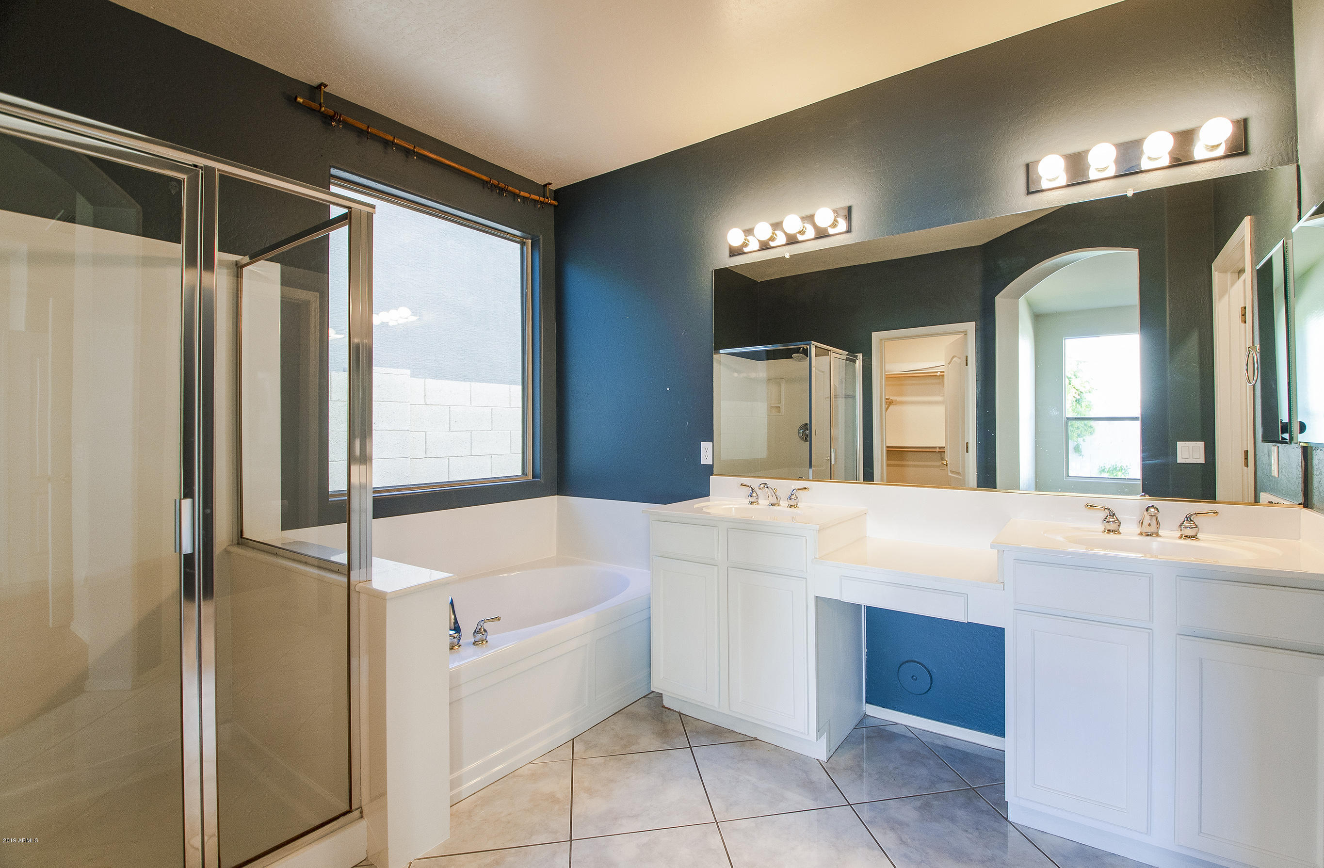 3236 East Phelps Street Gilbert, AZ 85295 - Photo 15 of 29 a bathroom with a tub sink and mirror
