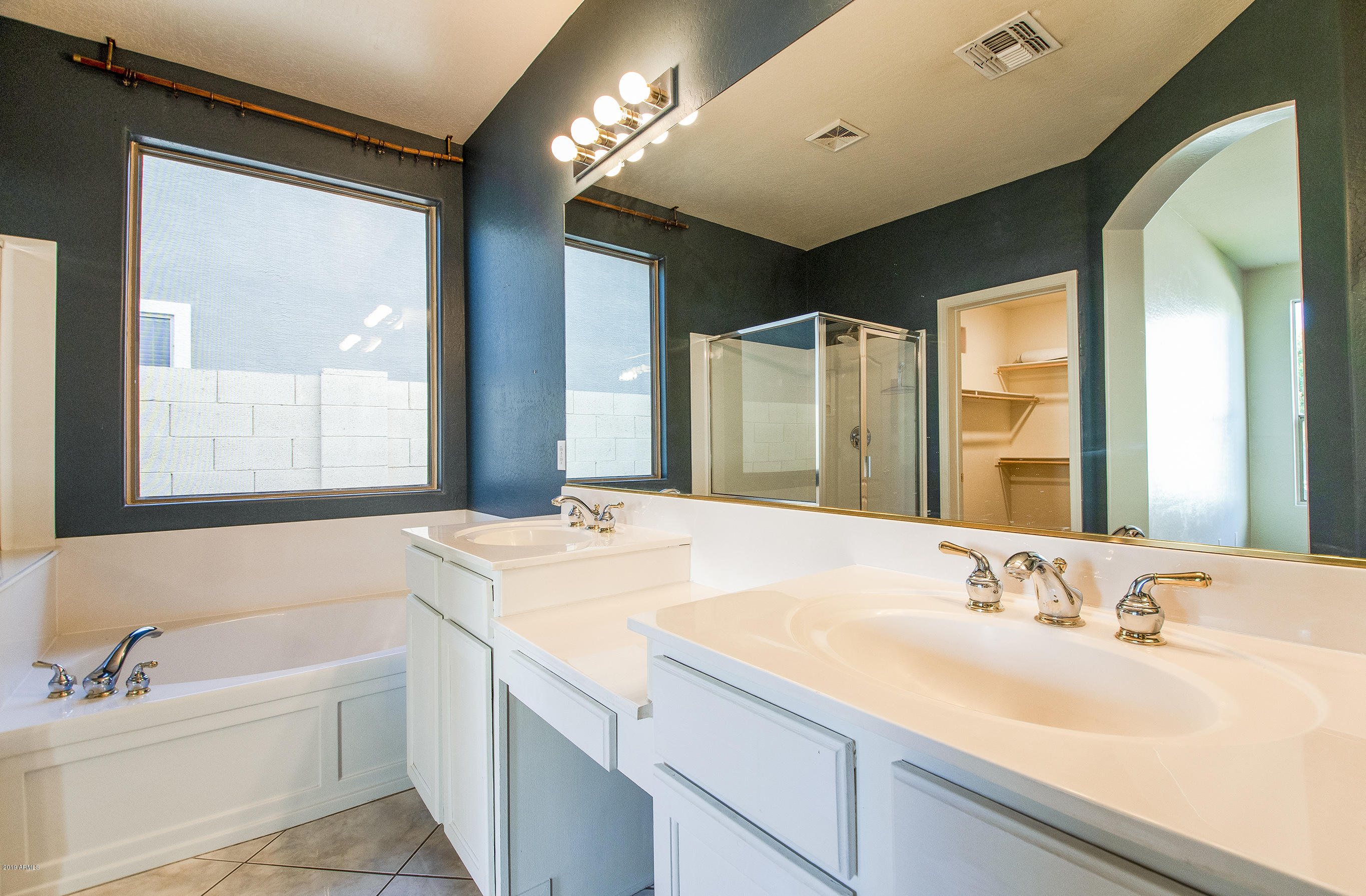 3236 East Phelps Street Gilbert, AZ 85295 - Photo 16 of 29 a bathroom with a tub sink and mirror