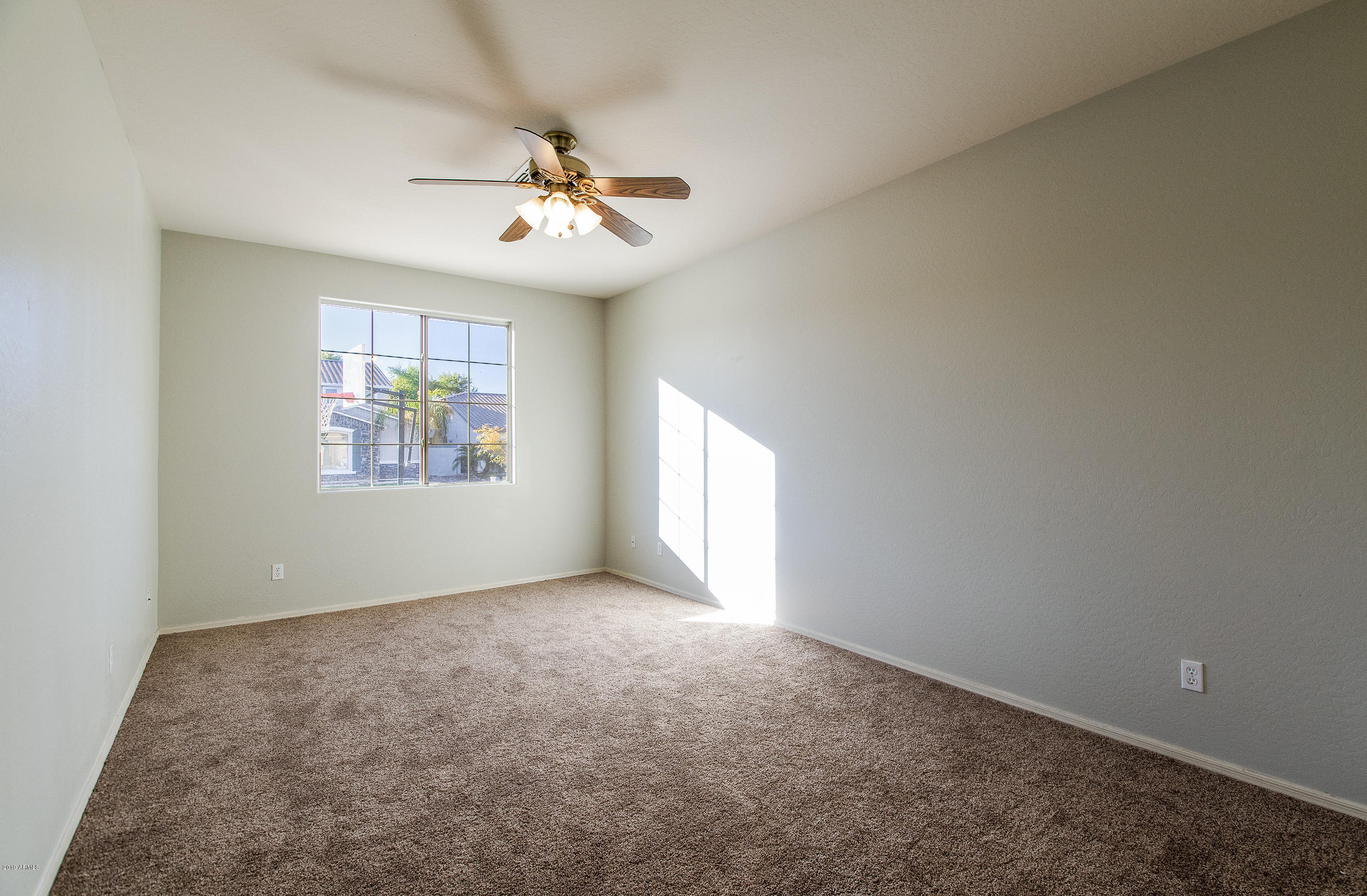 3236 East Phelps Street Gilbert, AZ 85295 - Photo 21 of 29 an empty room with windows and fan