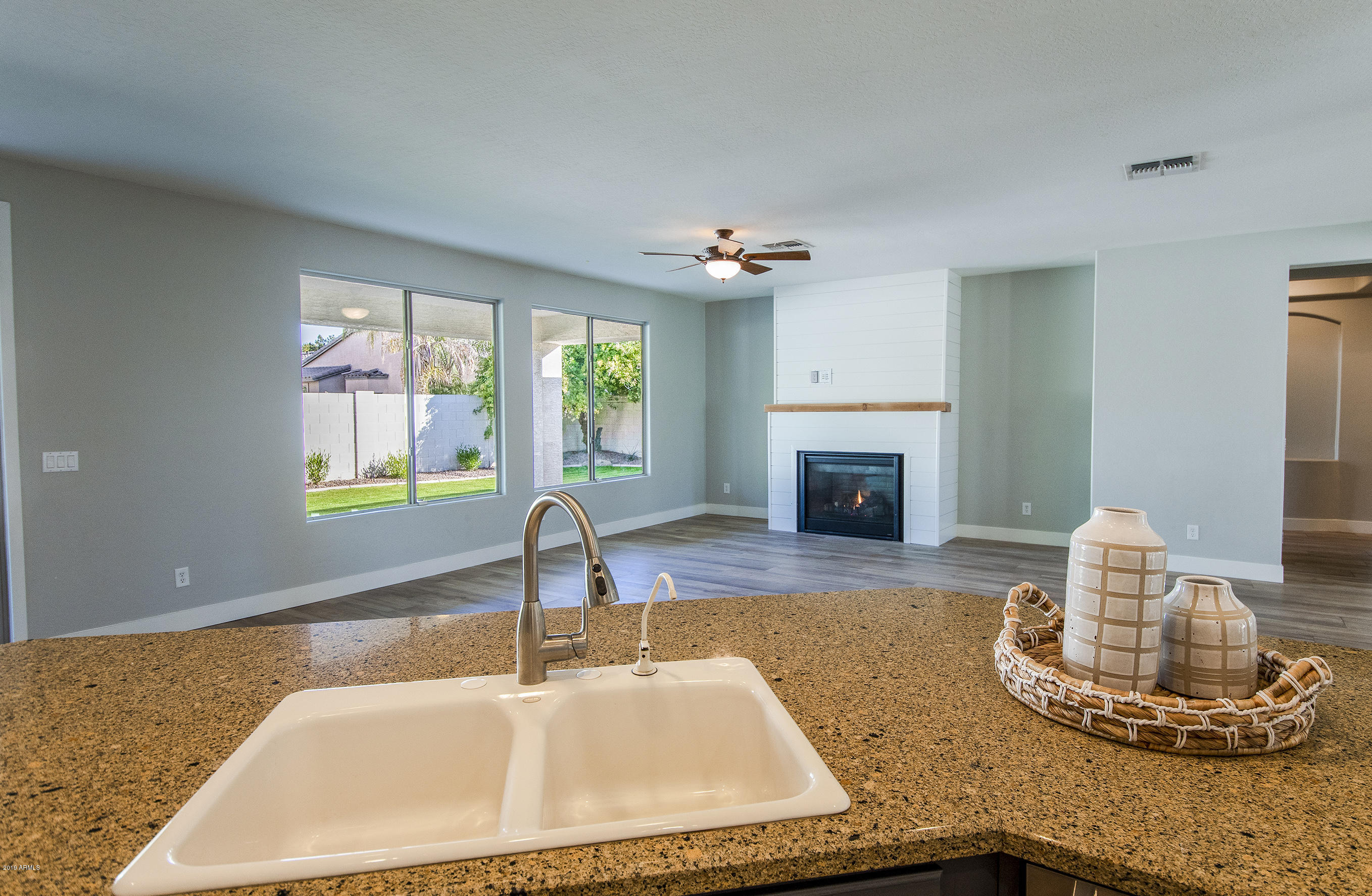 3236 East Phelps Street Gilbert, AZ 85295 - Photo 6 of 29 a kitchen with a sink and a fireplace