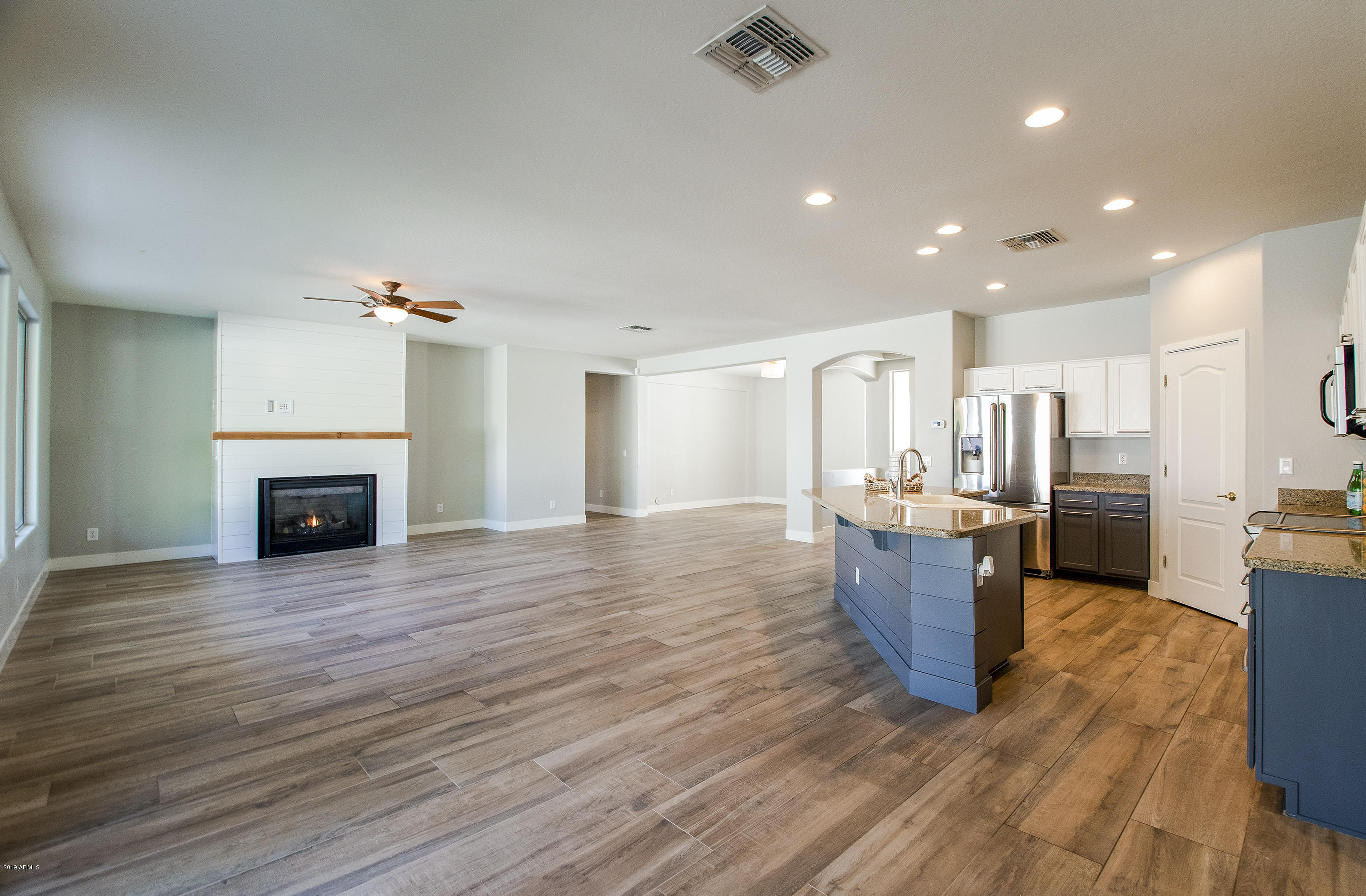 3236 East Phelps Street Gilbert, AZ 85295 - Photo 9 of 29 a view of kitchen and hall with wooden floor
