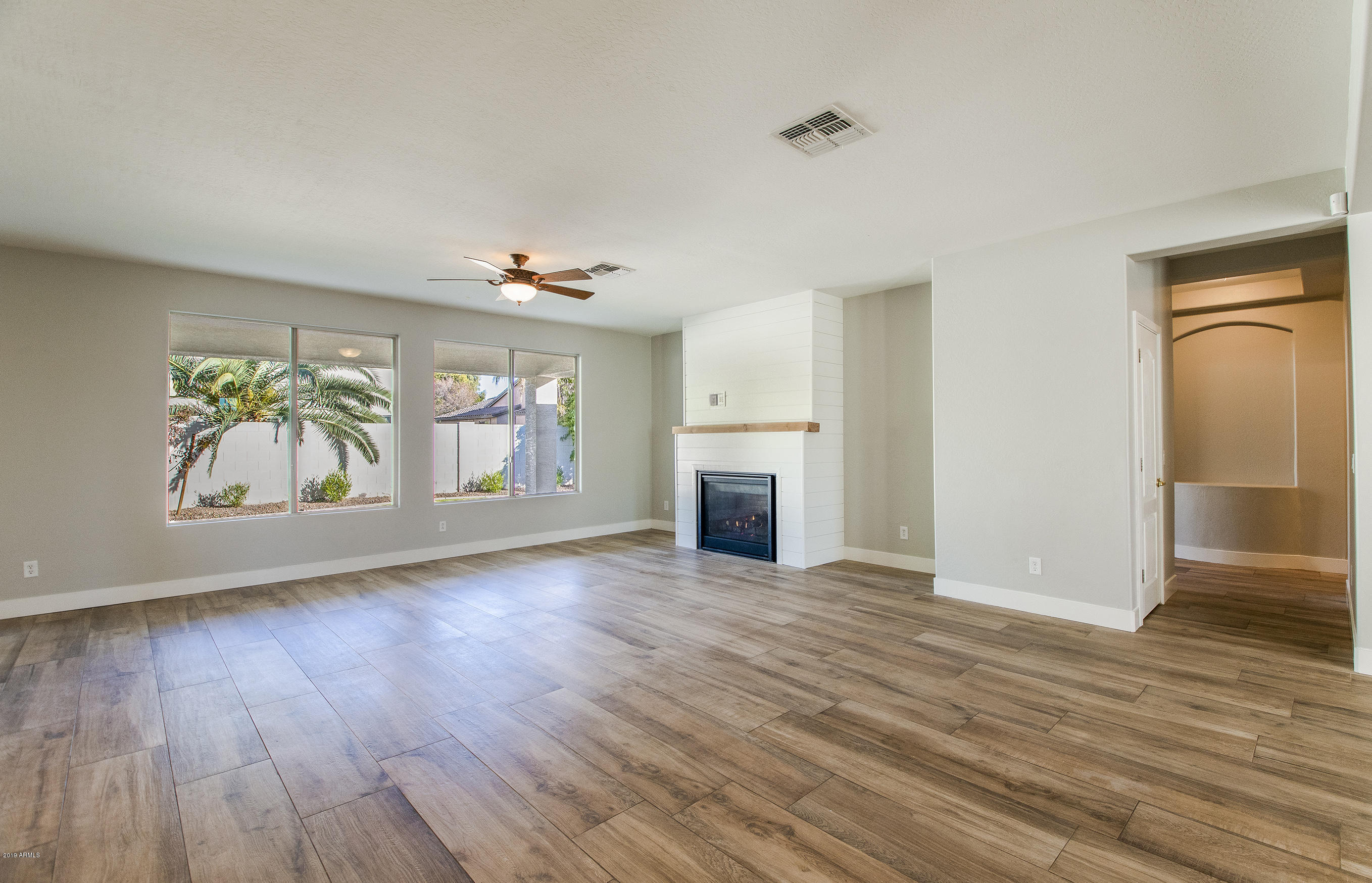 3236 East Phelps Street Gilbert, AZ 85295 - Photo 10 of 29 an empty room with wooden floor and a window