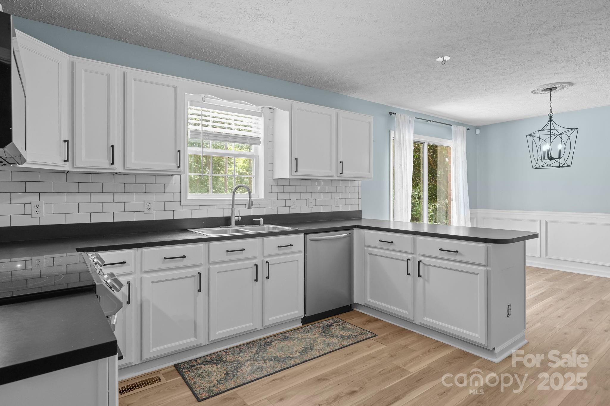25611 Bridgeport Road Albemarle, NC 28001 - Photo 19 of 47 a kitchen with granite countertop white cabinets sink and window