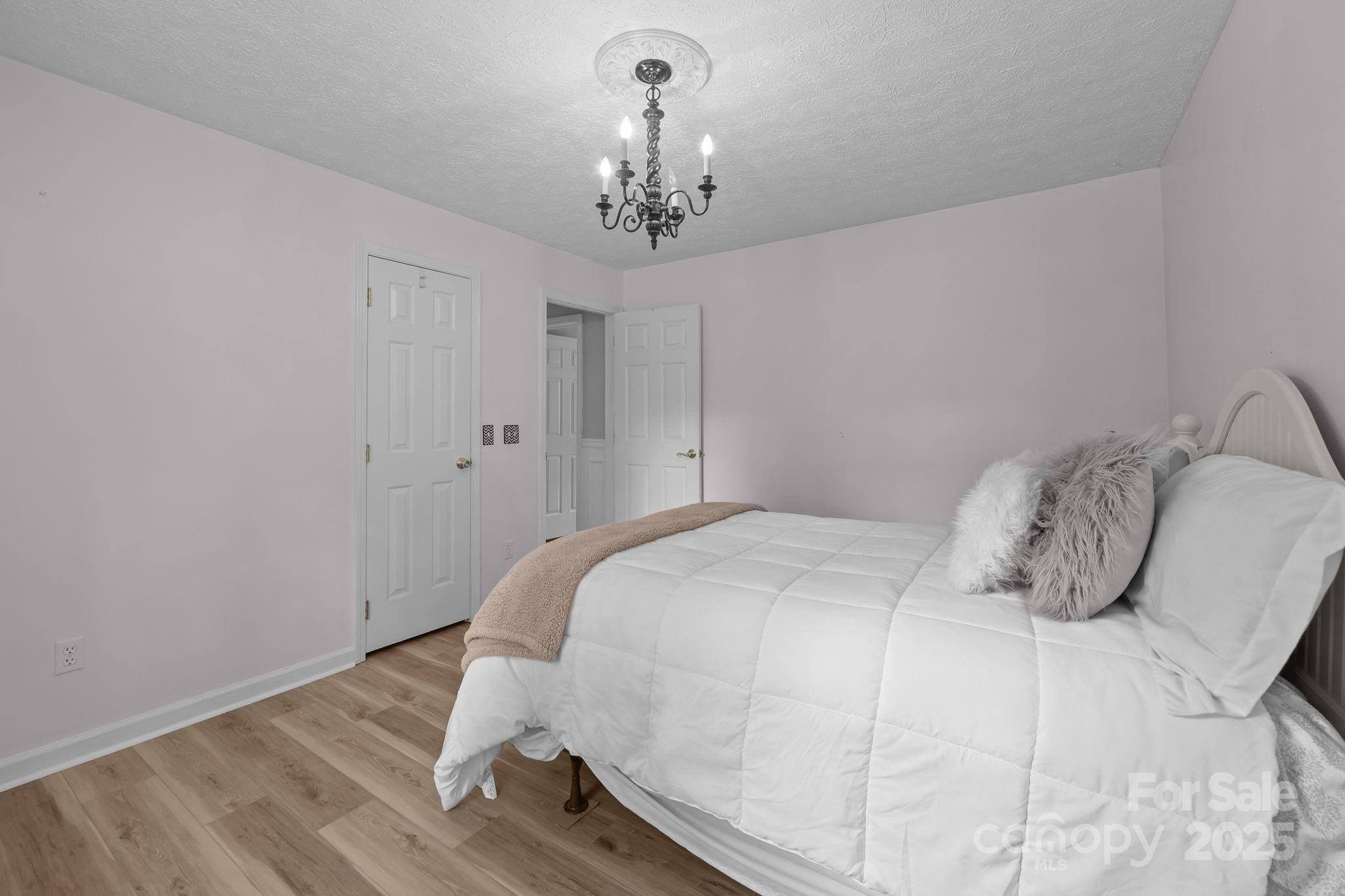 25611 Bridgeport Road Albemarle, NC 28001 - Photo 35 of 47 a bedroom with a bed and wooden floor