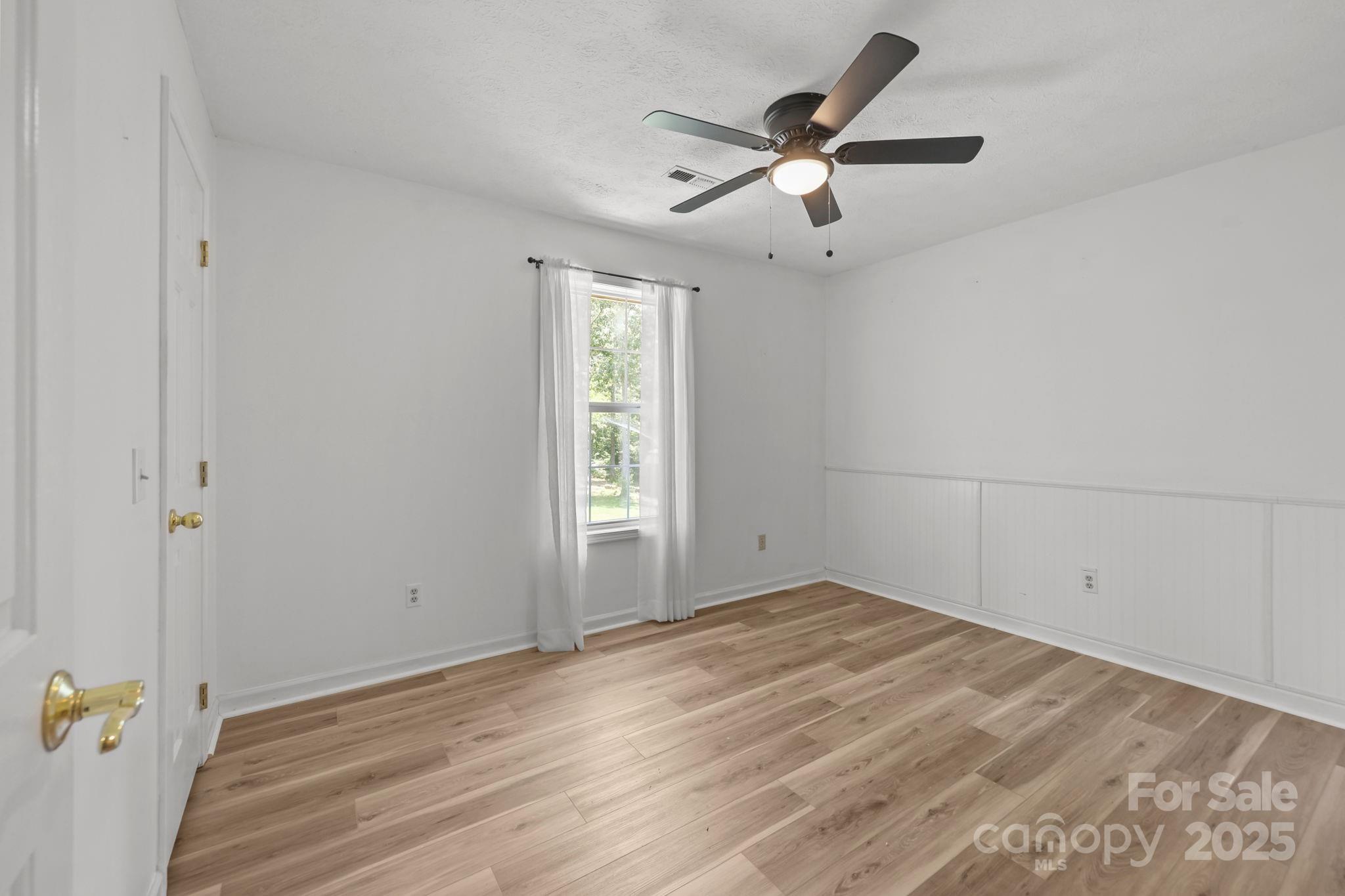 25611 Bridgeport Road Albemarle, NC 28001 - Photo 36 of 47 an empty room with a window and a ceiling fan