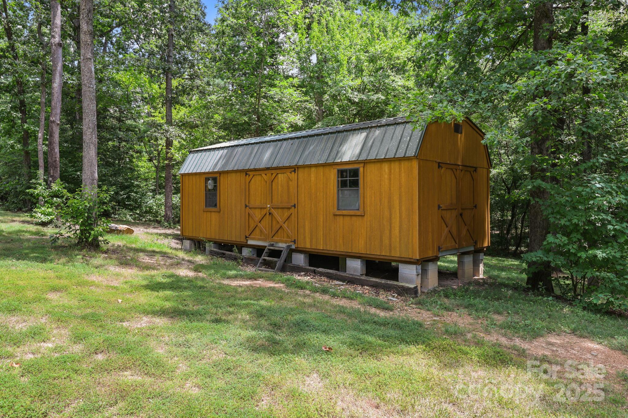 25611 Bridgeport Road Albemarle, NC 28001 - Photo 47 of 47 a view of a backyard with a small cabin