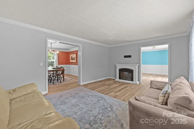 a view of a dining room with furniture and chandelier