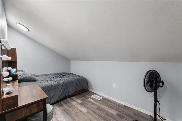 a bedroom with a bed and a chandelier
