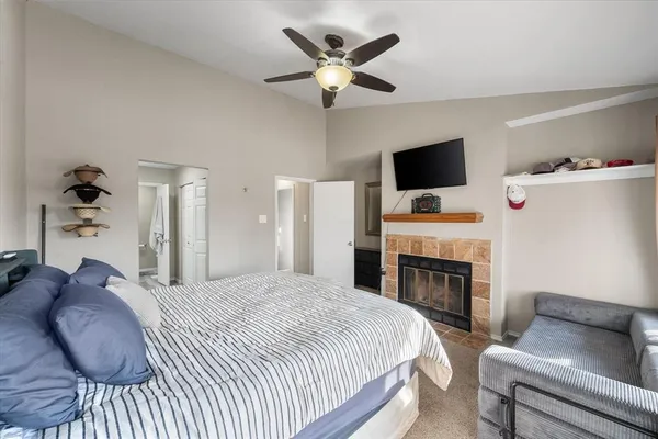 a bedroom with a bed a flat screen tv and a couch