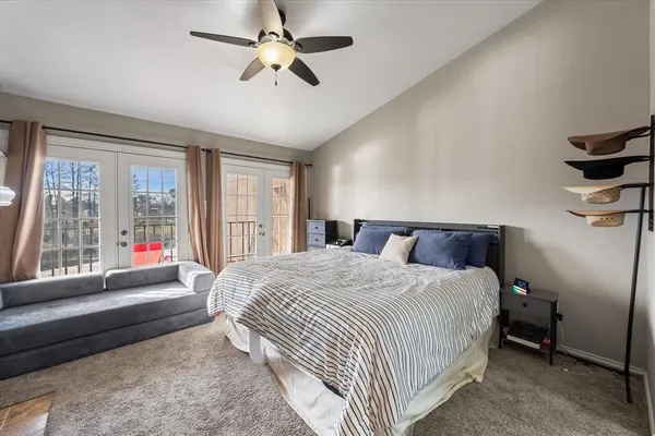 a spacious bedroom with a bed and a large window