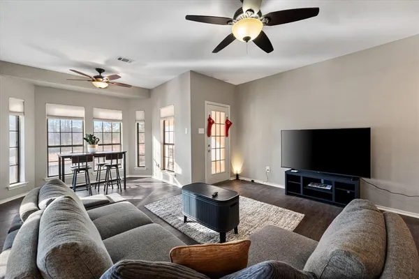 a living room with furniture and a flat screen tv