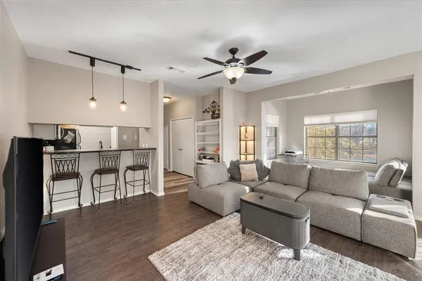 a living room with furniture or kitchen view and a wooden floor