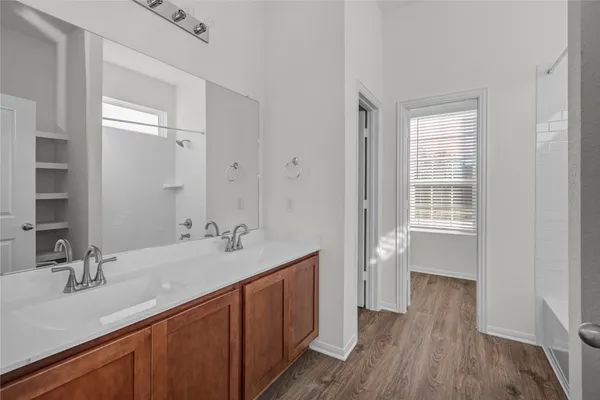 a bathroom with a double vanity sink and a mirror