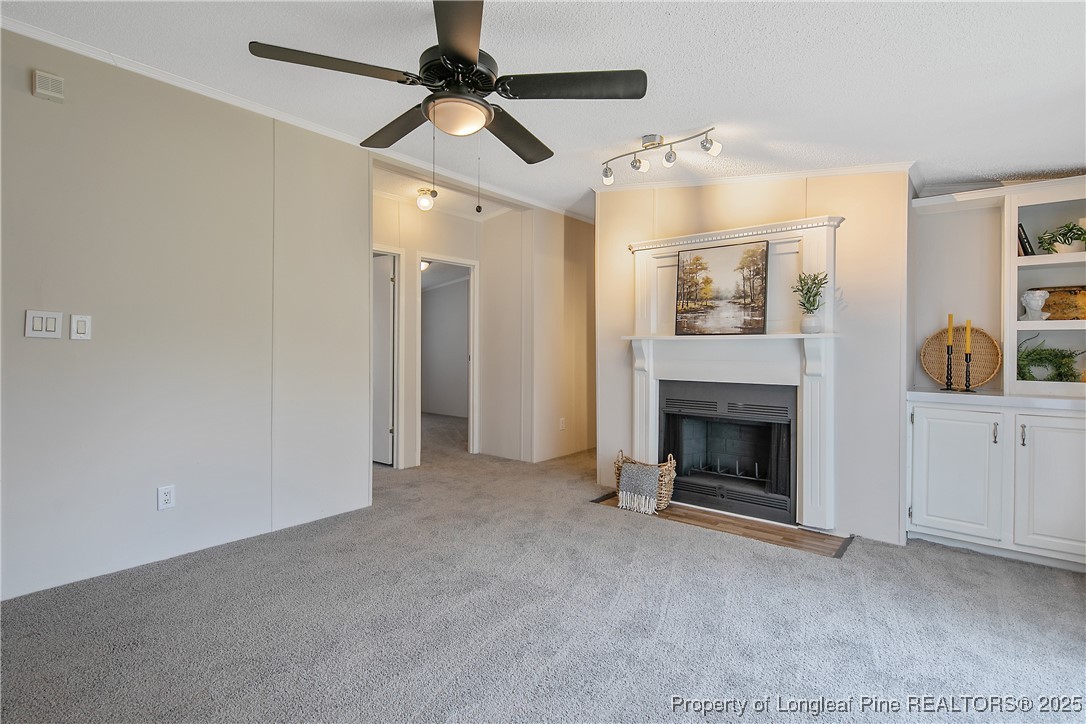 43 Columbus Court Spring Lake, NC 28390 - Photo 12 of 22 a view of a livingroom with a fireplace and fan