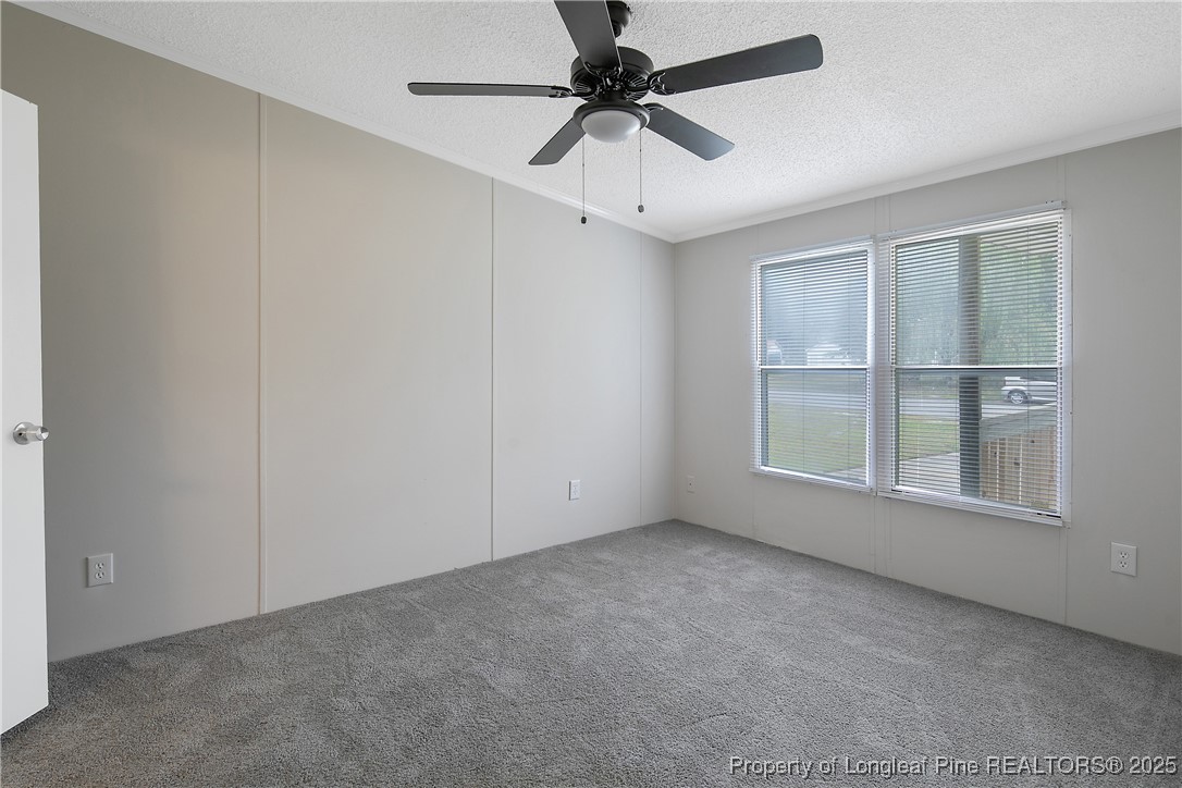 43 Columbus Court Spring Lake, NC 28390 - Photo 19 of 22 an empty room with a window and a fan