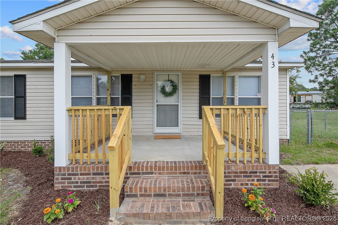 43 Columbus Court Spring Lake, NC 28390 - Photo 2 of 22 a view of front door of house with outdoor seating