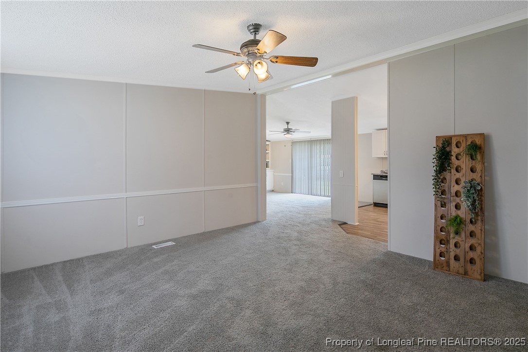 43 Columbus Court Spring Lake, NC 28390 - Photo 4 of 22 a view of an empty room with a ceiling fan