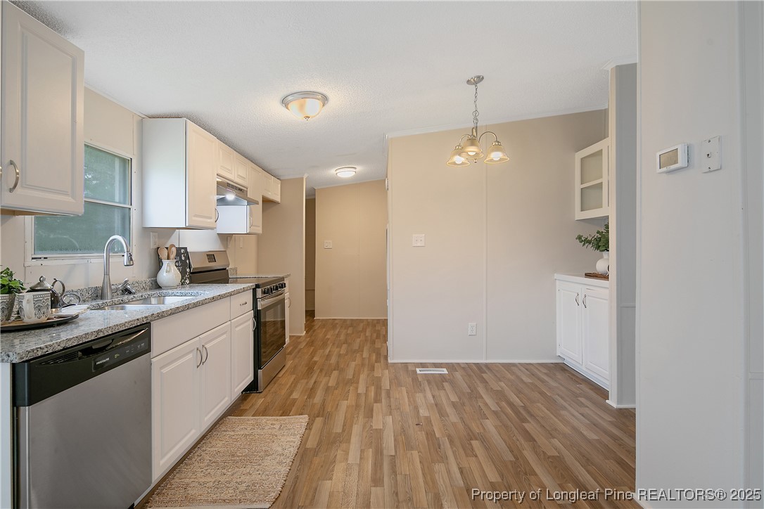 43 Columbus Court Spring Lake, NC 28390 - Photo 6 of 22 a kitchen with a sink and wooden floor