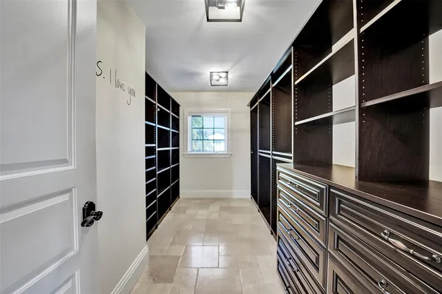 a front view of a house with a yard and potted plants