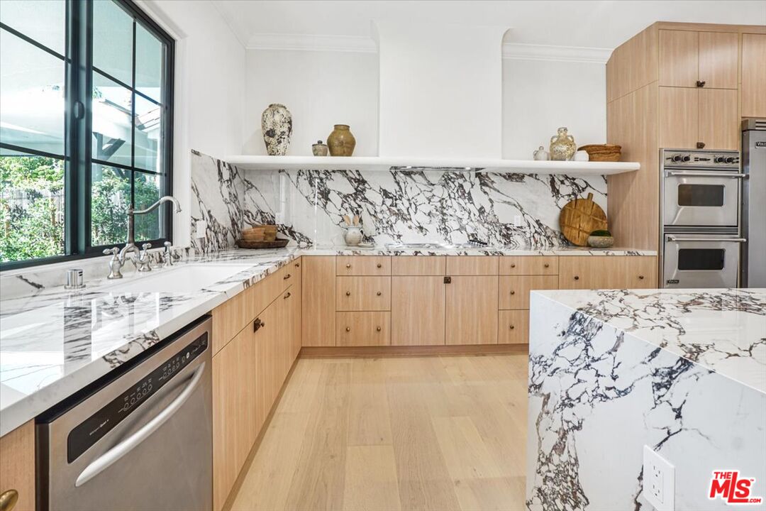 5717 Topeka Drive Tarzana, CA 91356 - Photo 16 of 52 a spacious bathroom with a sink and a large mirror