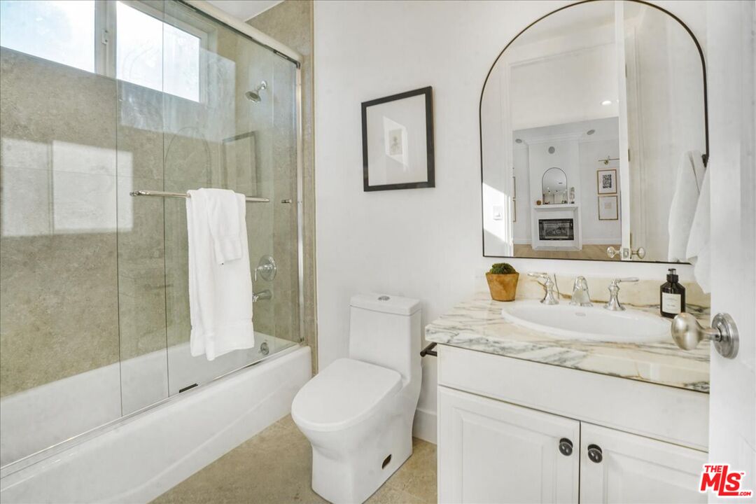 5717 Topeka Drive Tarzana, CA 91356 - Photo 25 of 52 a bathroom with a granite countertop sink toilet and shower