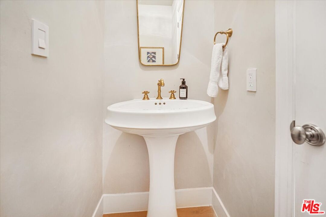 5717 Topeka Drive Tarzana, CA 91356 - Photo 26 of 52 a bathroom with a sink and a mirror