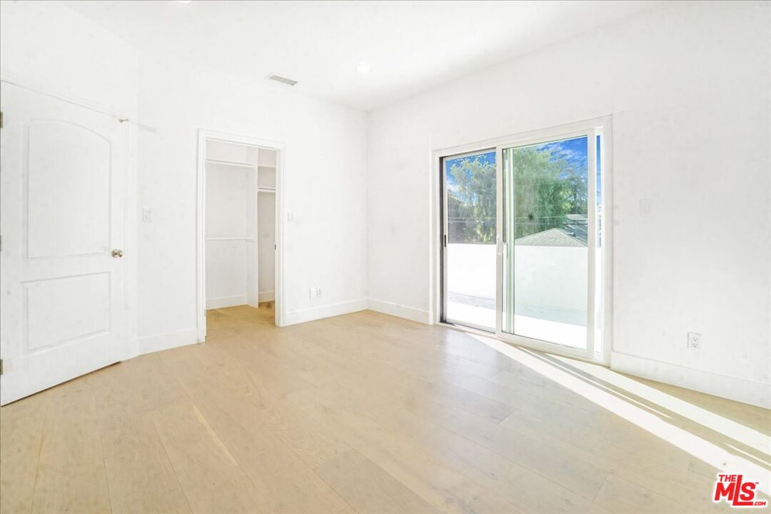 5717 Topeka Drive Tarzana, CA 91356 - Photo 37 of 52 an empty room with sliding door