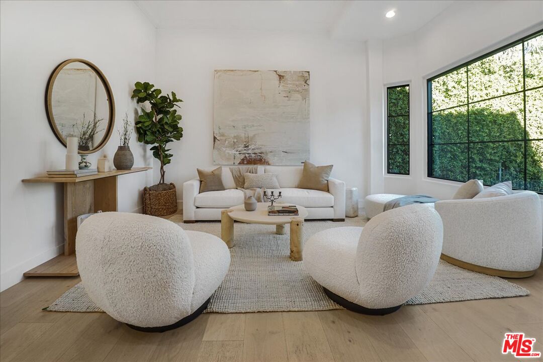 5717 Topeka Drive Tarzana, CA 91356 - Photo 4 of 52 a living room with furniture and a large window