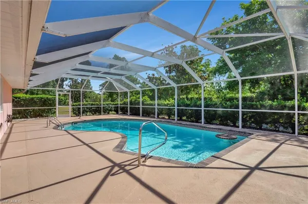 a view of a backyard with a swimming pool