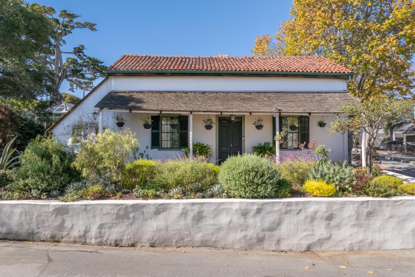 front view of a house with potted plants