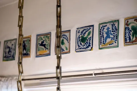 a view of a hallway with painting on the wall