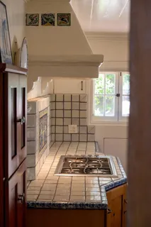 a stove top oven sitting inside of a kitchen