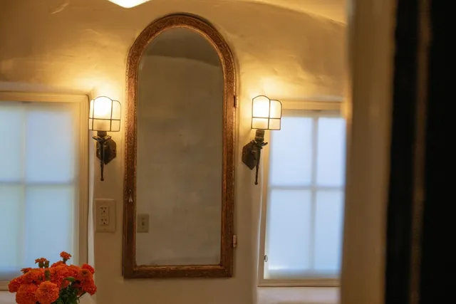 a bathroom with a glass shower door and a mirror