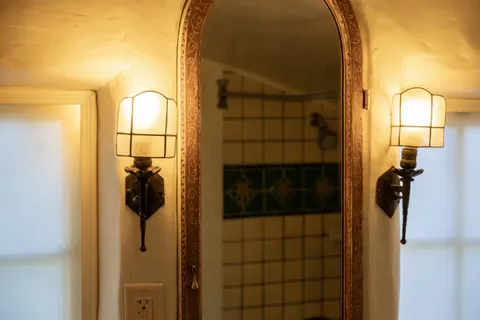 a bathroom with a glass shower door and a mirror