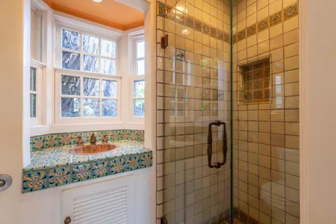 a bathroom with a shower and a sink