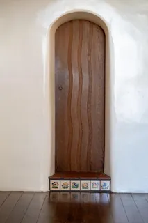 a view of a room with a wooden door