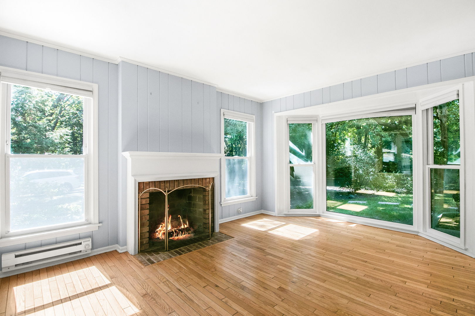 381 Wilson Street Winnetka, IL 60093 - Photo 7 of 28 a view of an empty room with wooden floor fireplace and a window