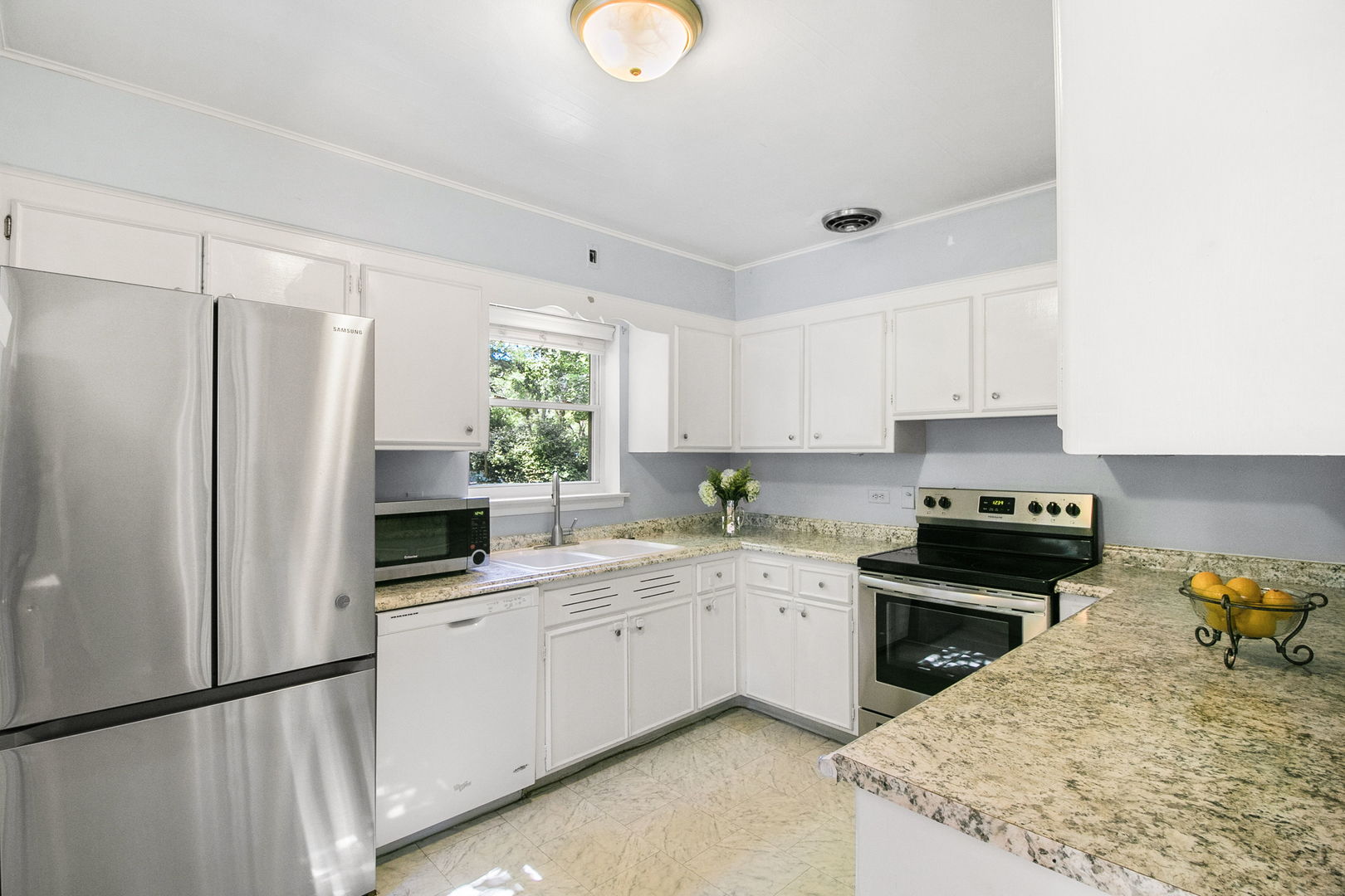 381 Wilson Street Winnetka, IL 60093 - Photo 8 of 28 a kitchen with a sink appliances and cabinets