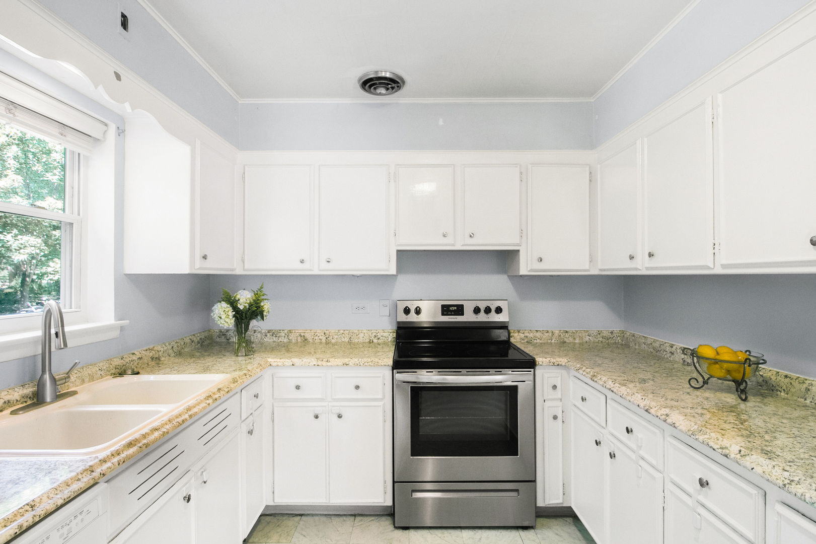 381 Wilson Street Winnetka, IL 60093 - Photo 9 of 28 a kitchen with granite countertop white cabinets and white appliances