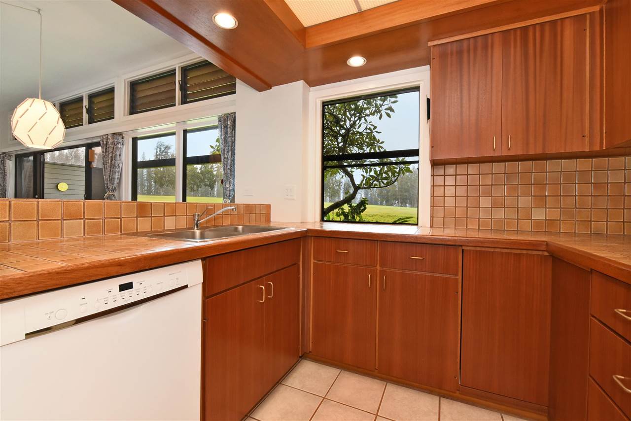 100 Ridge Road, Unit 2312 Lahaina, HI 96761 - Photo 14 of 30 a kitchen with stainless steel appliances granite countertop wooden cabinets a sink and a large window