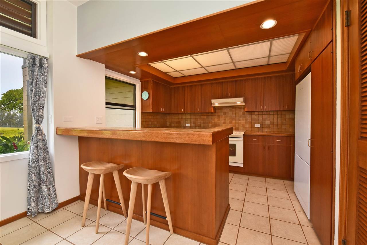 100 Ridge Road, Unit 2312 Lahaina, HI 96761 - Photo 17 of 30 a kitchen with a sink a refrigerator and cabinets